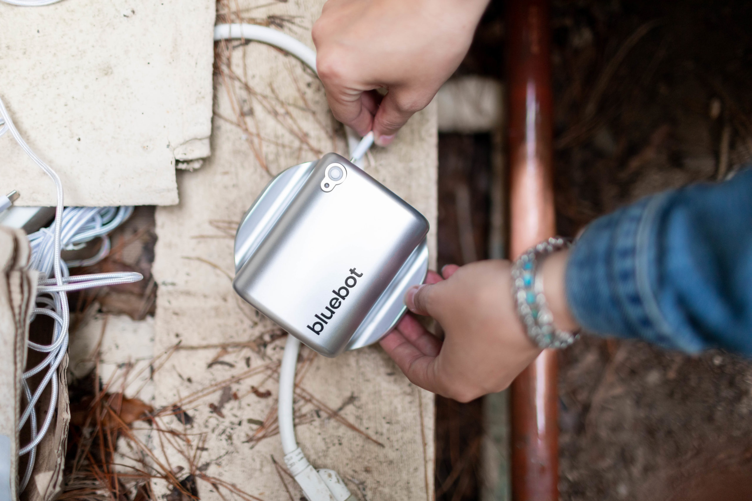 homeowner installing bluebot, a transit time flow meter for water pipes