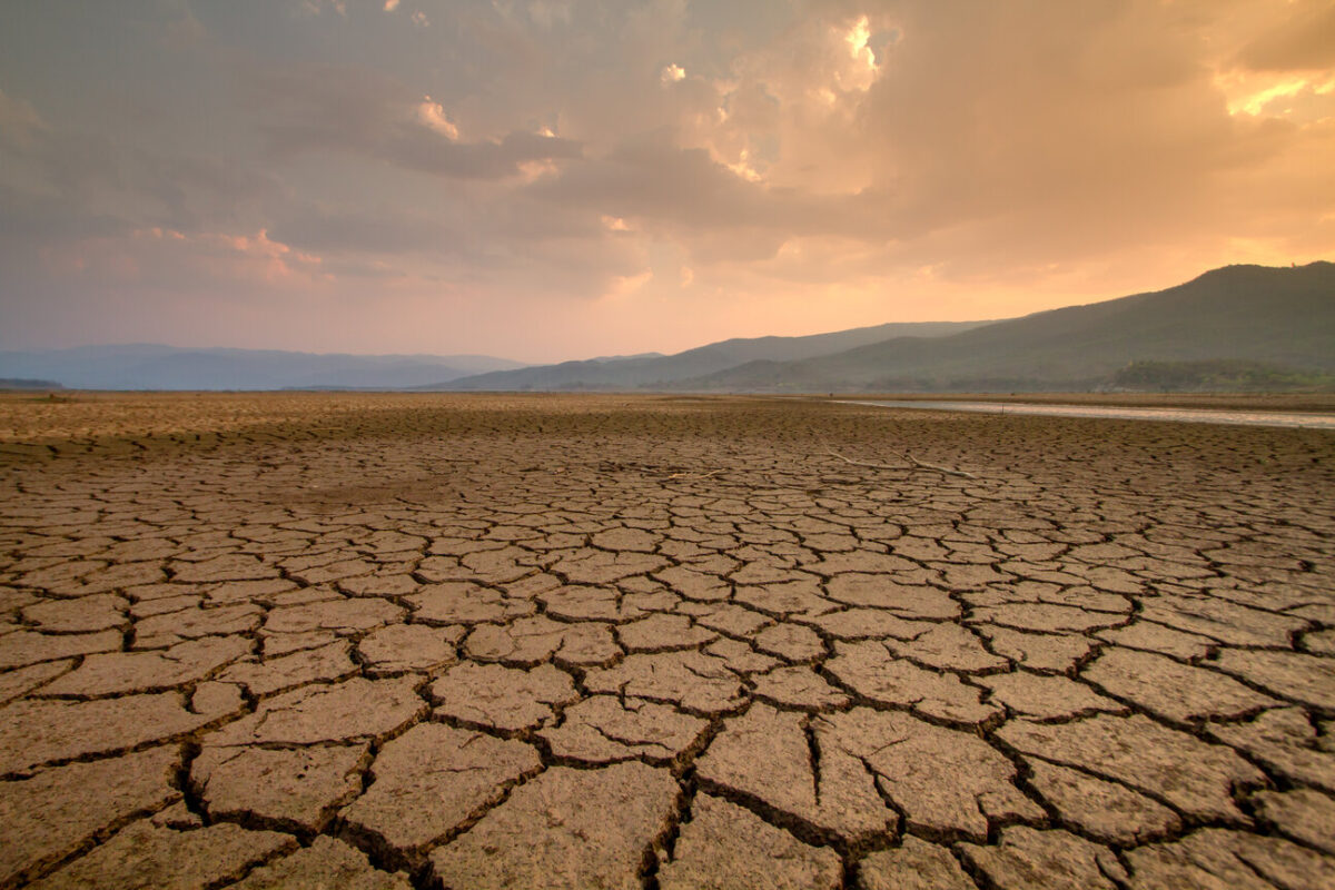 Cracked lakebed with mountains in the background